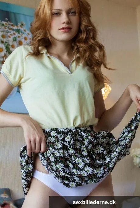 Natural redhead Shirley Tate hikes her skirt to expose shaved pussy