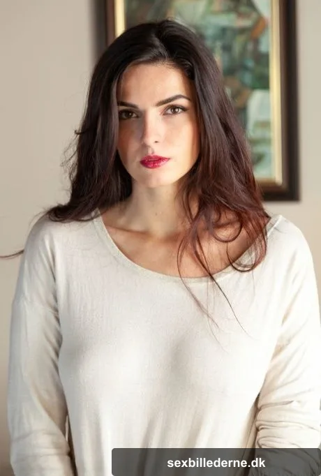 Long legged teen Cynthia Hill removes a long sleeved shirt to pose in the nude