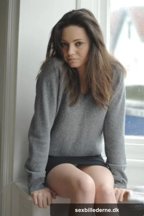 Brunette babe with a hairy twat Brionie W shows her small tits in a solo