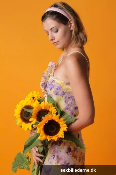 Sexy teen beauty Vienna flaunts her big tits and poses with sunflowers