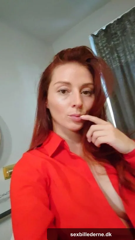 Gorgeous redhead shows off her big tits & her tattoos while taking nudes
