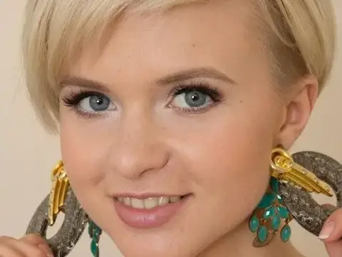 Young blonde with short hair shows her tiny tits and bald pussy as well