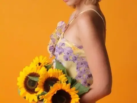 Sexy teen beauty Vienna flaunts her big tits and poses with sunflowers
