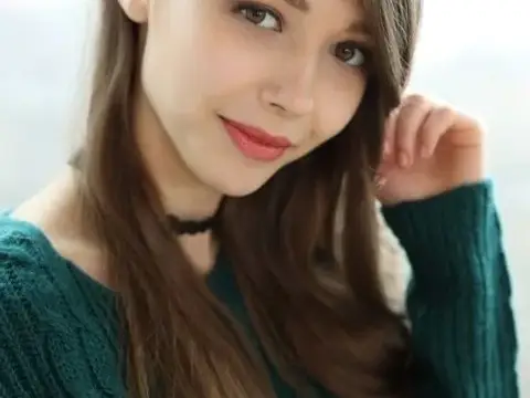 Beautiful teen frees her natural tits from a sweater before spreading her twat