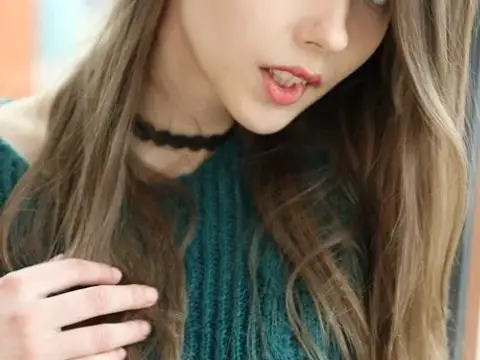 Beautiful teen frees her natural tits from a sweater before spreading her twat